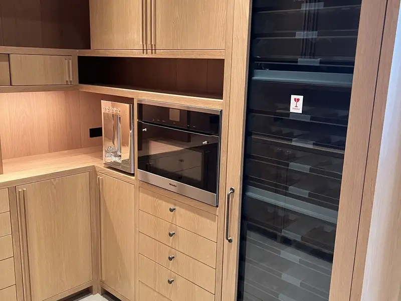 Light-oak pantry millwork with wine storage and oven stack