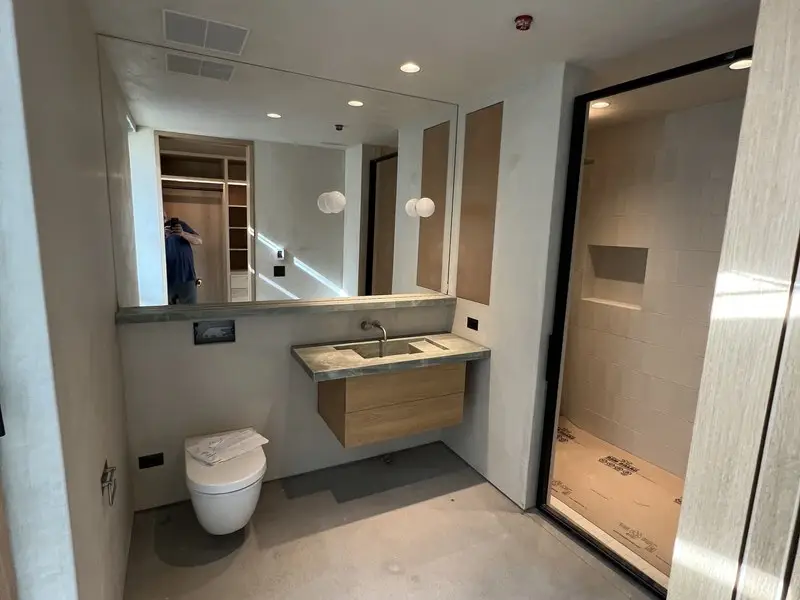 Modern bathroom with floating wood vanity and tiled wet zone