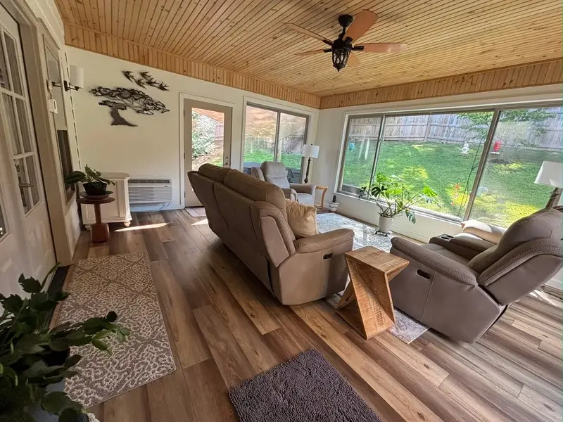 Sunroom with wood ceiling and full-height glass to the yard